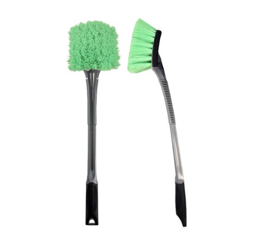 Two car cleaning brushes on a white background one with a fluffy round green head and the other with an angled green bristle head both with black and grey handles