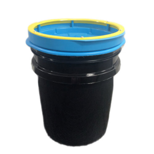 Photograph of a black textured filter container featuring a bright blue top rim and a thin yellow accent ring