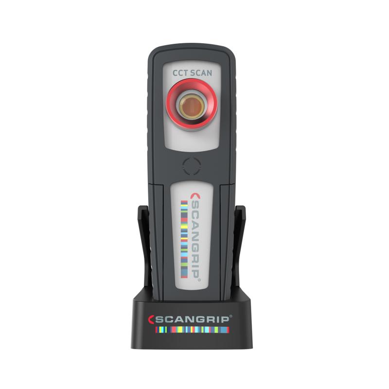A grey and white ScanGrip CCT SCAN portable work light standing upright with a red ring around its central lens and the brand's colorful striped logo