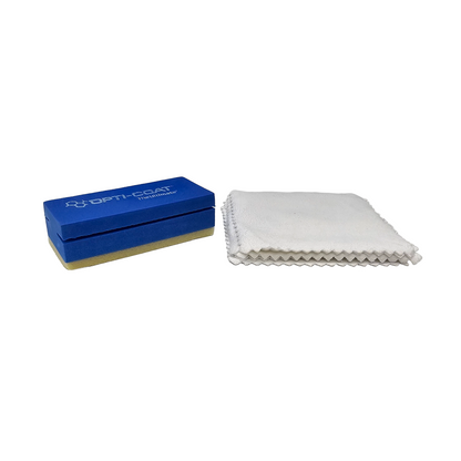 Product photo of a blue OPTI-COAT applicator block with a beige base alongside a folded white microfiber cloth with serrated edges on a white background