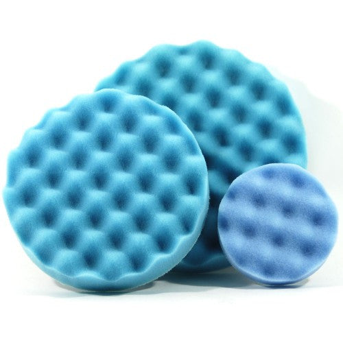 Three blue foam polishing pads with a waffle texture in various sizes on a white background