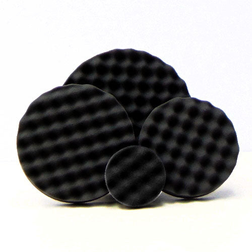Four black circular waffled foam pads of varying sizes