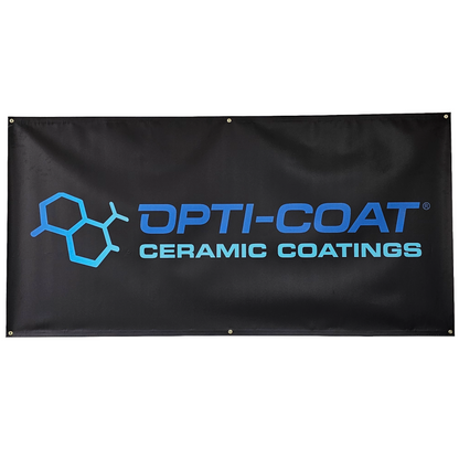 Black vinyl banner displaying the OPTI-COAT CERAMIC COATINGS logo with a blue molecular graphic and bright blue text, accented by metal grommets for hanging