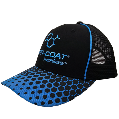 Black and blue trucker cap with an embroidered blue OPTI-COAT TheUltimate™ logo and chemical structure on the front, a blue brim with a black hexagonal honeycomb pattern, and black mesh back panels with blue piping