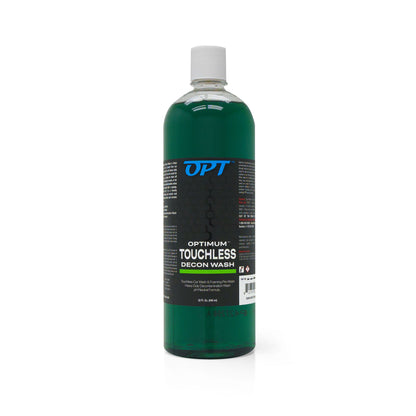 Photograph of a clear plastic bottle of Optimum Touchless Decon Wash, filled with dark green liquid and a white screw cap, displaying the blue OPT logo and label details including 'Touchless Car Wash & Foaming Pre-Wash Heavy Duty Decontamination Wash pH Neutral Formula' in a 32 fl oz (946 ml) size against a white background