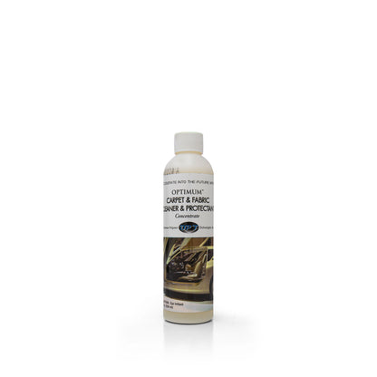 Product photo of a white plastic bottle of Optimum Carpet & Fabric Cleaner & Protectant Concentrate on a white background, featuring a label with the product name and an image of a clean tan car interior with visible dashboard and door panel