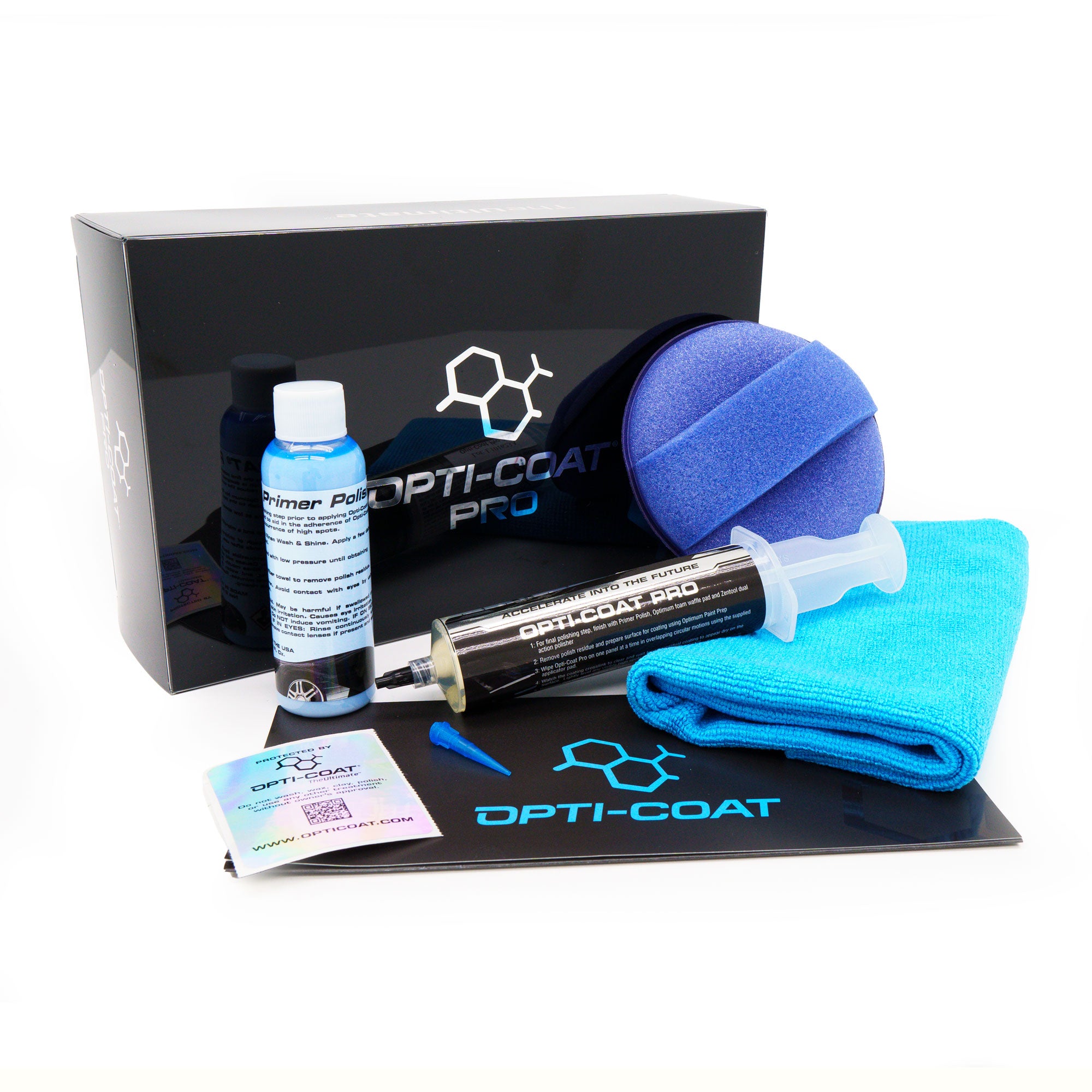 Opti-Coat Pro car detailing kit on a white background displaying a black branded box, a blue primer polish bottle, a syringe of ceramic coating, a blue applicator pad, and a turquoise microfiber towel