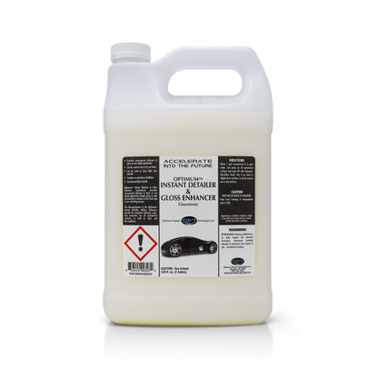 Optimum Polymer Technologies white plastic one-gallon jug of Instant Detailer & Gloss Enhancer Concentrate featuring a label with a glossy black sports car graphic, a red warning symbol, and the text ACCELERATE INTO THE FUTURE