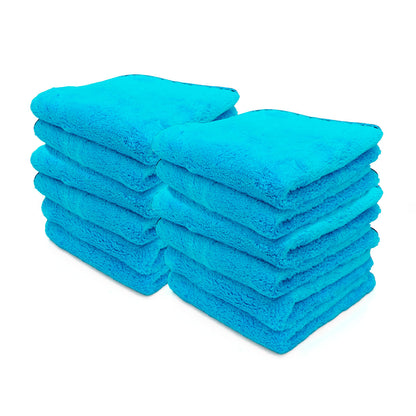 Product photography showing two neat stacks of vibrant aqua blue plush microfiber towels neatly folded against a clean white background
