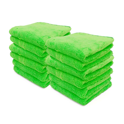Two stacks of neatly folded vibrant lime green plush microfiber cleaning cloths on a crisp white background