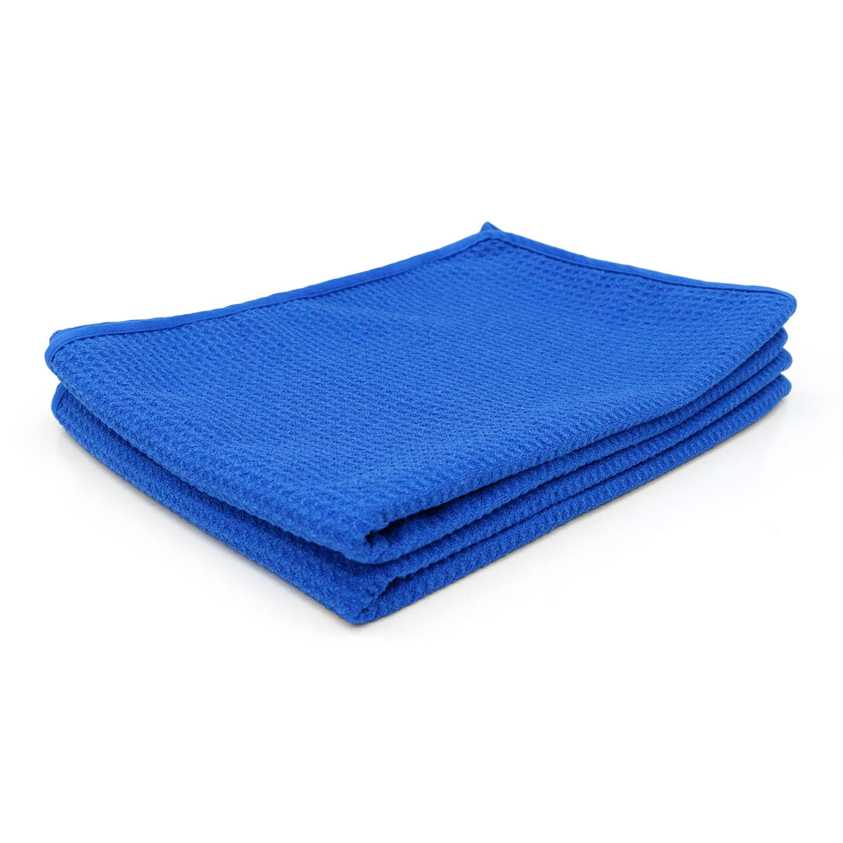 A neatly folded royal blue microfiber cleaning towel showcasing its waffle-weave texture and overlocked edge on a clean white background