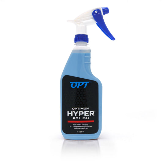 Product shot of an Optimum Hyper Polish spray bottle on a white background, featuring light blue liquid, a black label with white and blue text and a red line, and a white and royal blue spray nozzle
