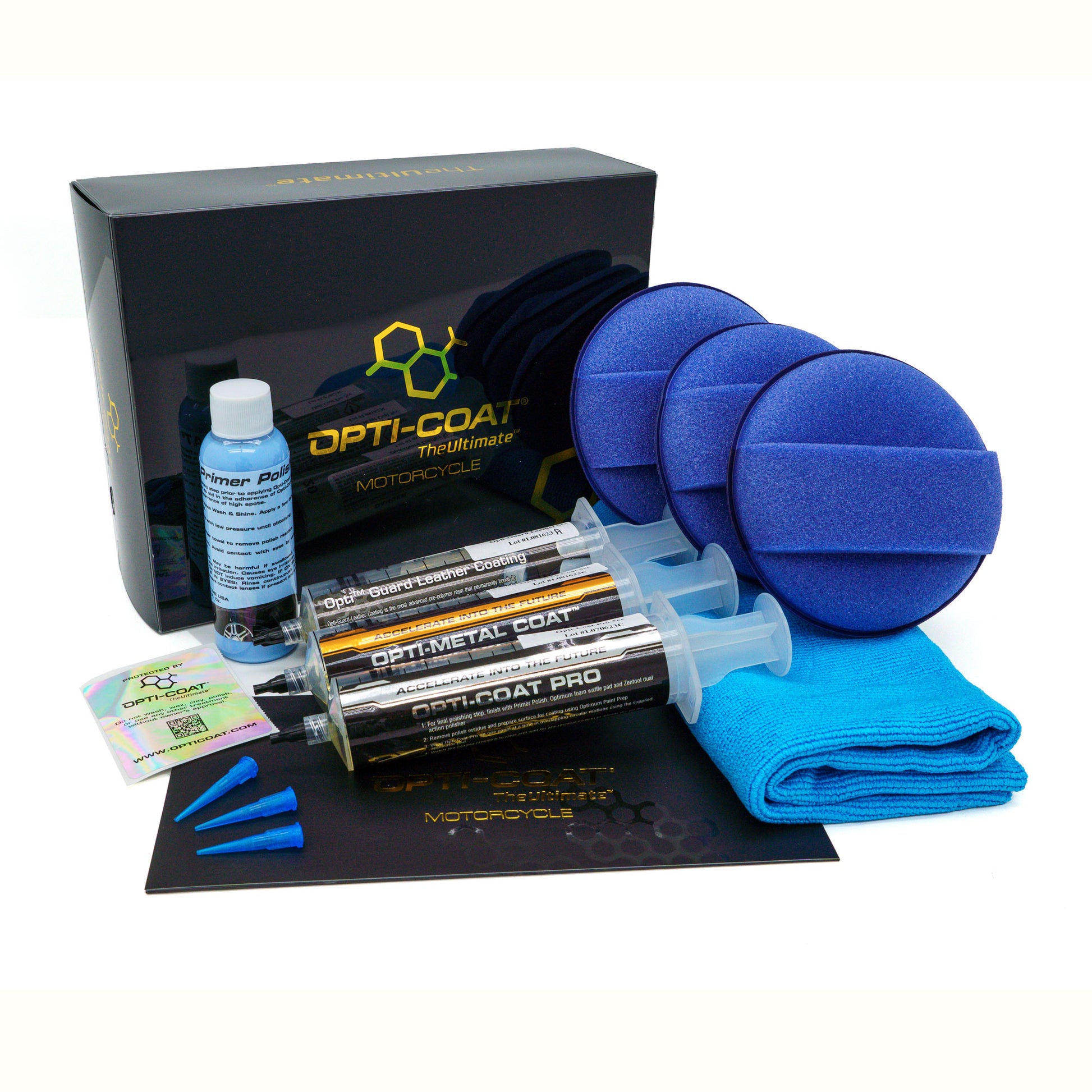 Product photography of the Opti-Coat The Ultimate Motorcycle detailing kit on a white background featuring a black box, a blue Primer Polish bottle, three clear syringes for Opti-Guard Leather, Metal, and Pro coatings, three vibrant blue applicator pads, and a folded blue microfiber towel