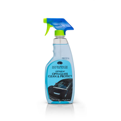 Photograph of an Optimum Opti-Glass Clean & Protect spray bottle on a white background featuring a clear bottle with blue liquid, a vibrant green and blue spray nozzle, and a label displaying a black car with "ACCELERATE INTO THE FUTURE" text