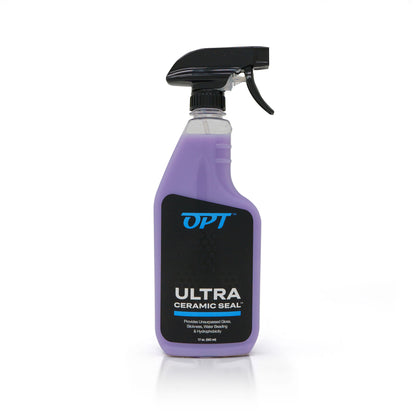 Product photograph of a clear bottle of OPT Ultra Ceramic Seal car care product with vibrant purple liquid and a black spray trigger on a white background