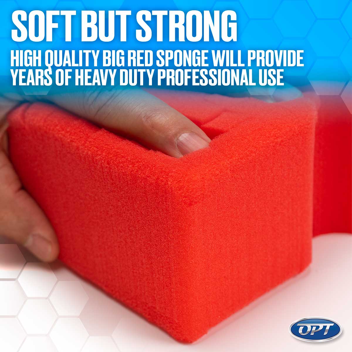 A hand gently compressing a vibrant red rectangular foam sponge with a blue and white hexagonal background displaying the bold white text 'SOFT BUT STRONG HIGH QUALITY BIG RED SPONGE' and a blue OPT logo