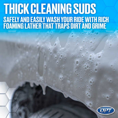 Photograph of thick white cleaning suds with numerous bubbles clinging to and dripping from a grey car body panel, featuring a blue gradient background with promotional text about rich foaming lather for safe washing and the OPT logo