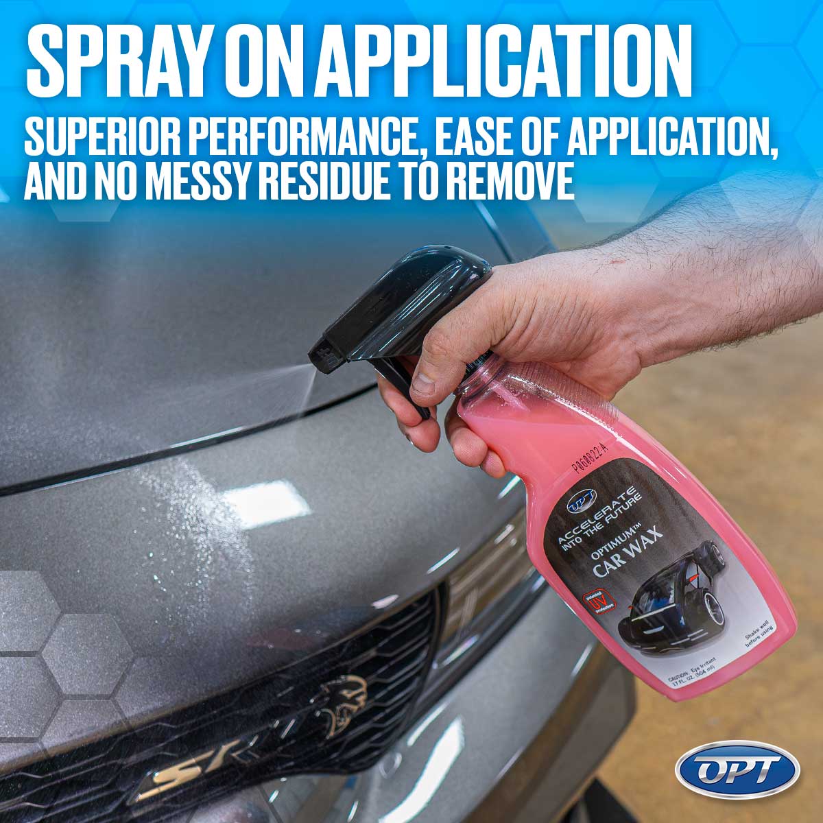 Photograph of a hand spraying pink Optimum Car Wax onto the grey metallic hood of a Dodge SRT with a Hellcat logo visible on the grille, featuring "SPRAY ON APPLICATION" text overlay