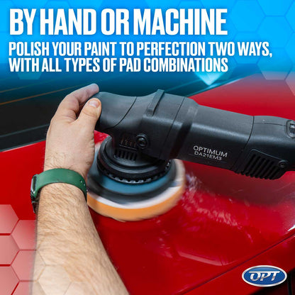 Photograph of a hand operating a black Optimum DA21EM3 dual-action polisher with a yellow foam pad on a vibrant red car surface showing polishing compound and a green smartwatch band