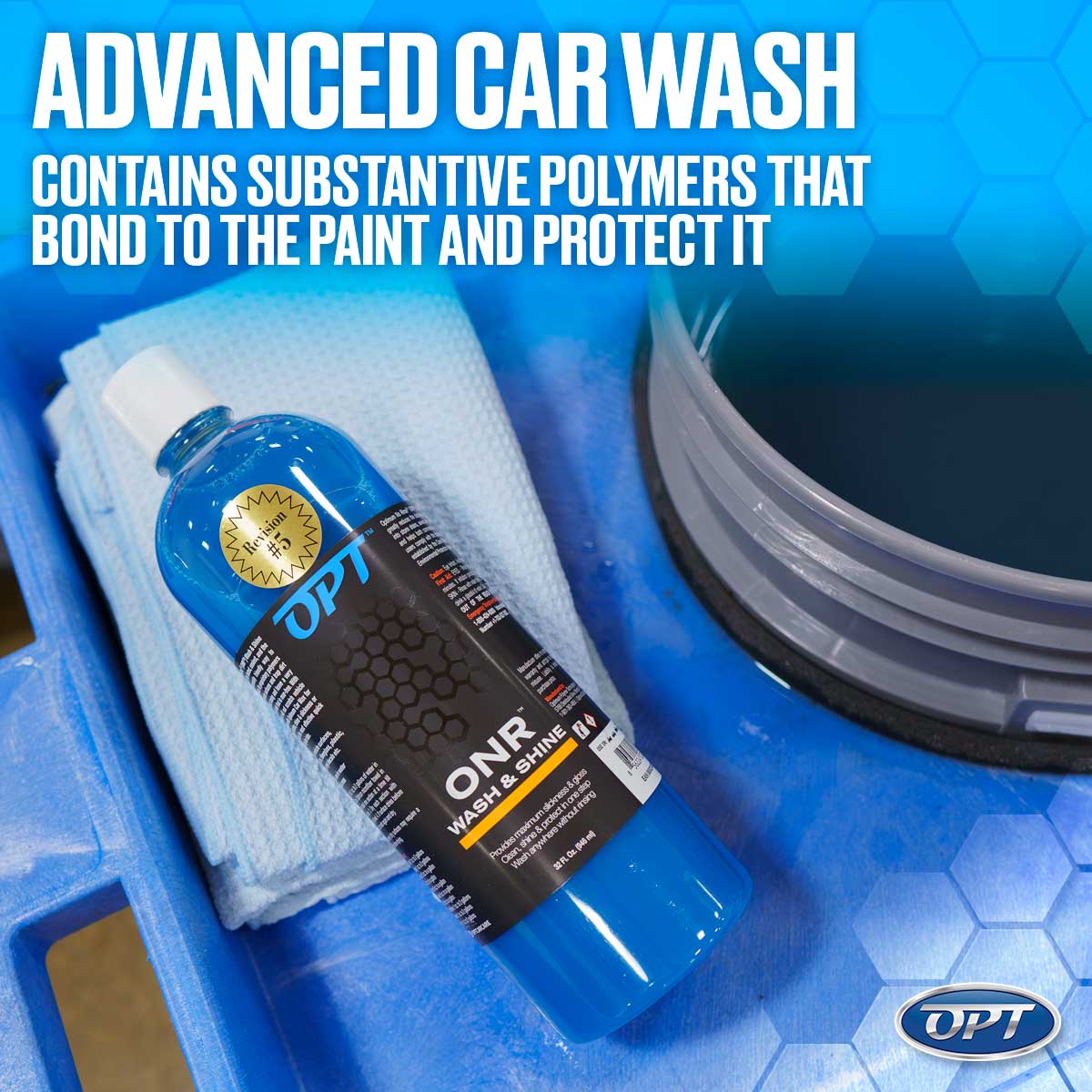 OPT ONR Wash & Shine in a bright blue bottle with a gold Revision #5 sticker and a light blue microfiber towel in a blue detailing bin, alongside a grey bucket of dark blue liquid, highlighted by bold white text reading ADVANCED CAR WASH CONTAINS SUBSTANTIVE POLYMERS THAT BOND TO THE PAINT AND PROTECT IT