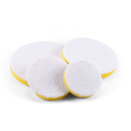 Four circular white fluffy polishing pads with yellow foam backing in various sizes