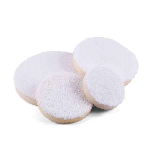 A cluster of four round white car detailing polishing pads of varying sizes, featuring fluffy textured surfaces and light beige undersides, on a pristine white background