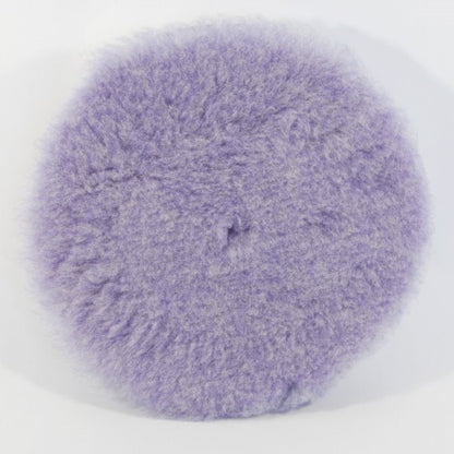 A circular lavender purple fluffy buffing pad with a soft shaggy texture on a clean white background