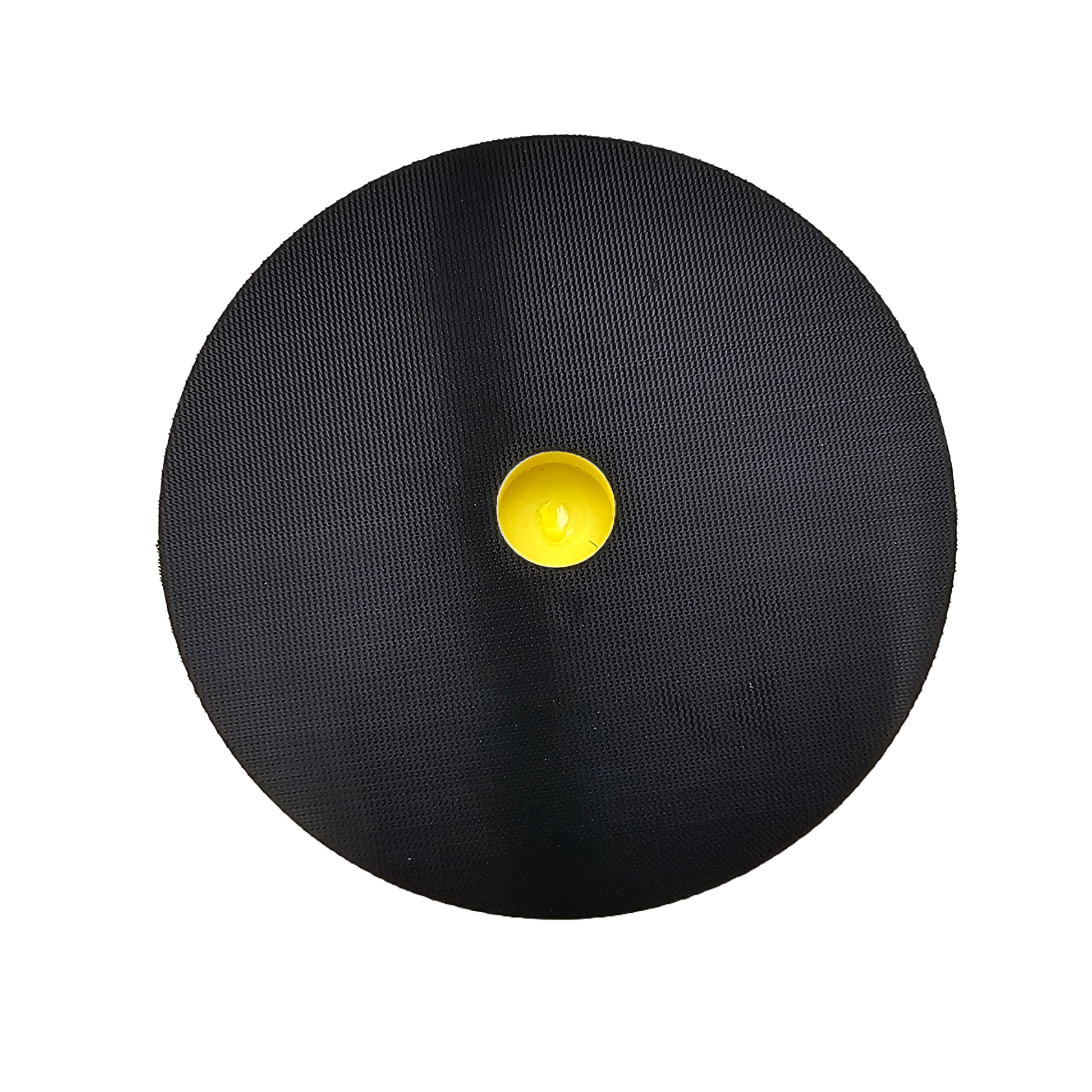 Minimalist photography: a perfectly circular black object with a distinct fine mesh texture and a bright, slightly concave yellow center presented on a pure white background