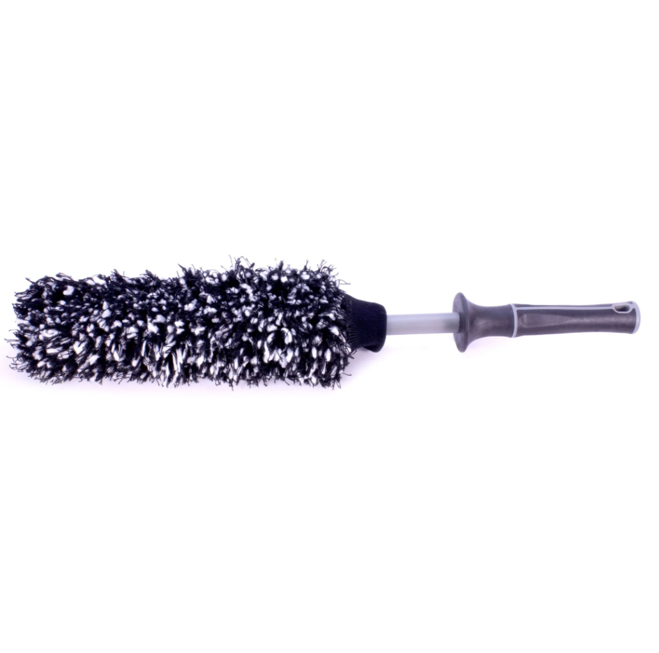 Microfiber car wheel brush featuring a black and white fluffy head a grey shaft and a dark grey ergonomic handle