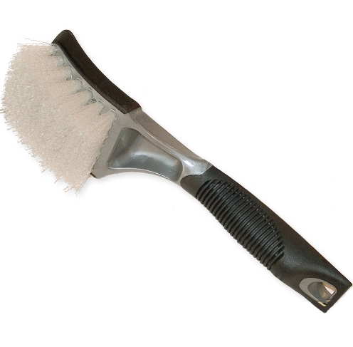 A close-up of a brush with white bristles, a shiny grey metal body, and a black ergonomic handle featuring ribbed grips and a hanging loop