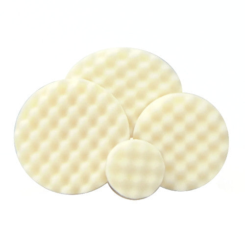 Four cream-colored circular foam polishing pads with a distinct waffle texture in varying sizes