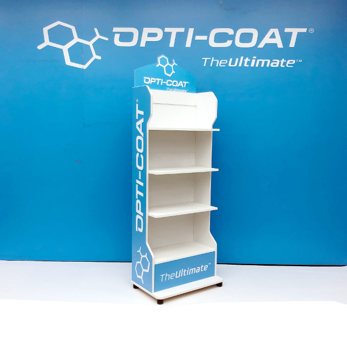 Product photograph of an Opti-Coat branded point-of-sale display shelf featuring four white tiers, white "OPTI-COAT TheUltimate" text and chemical structure logo, set against a bright blue studio wall
